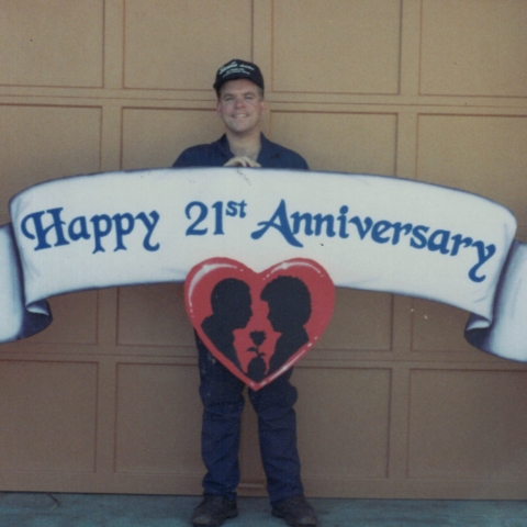 Robert holding custom sign