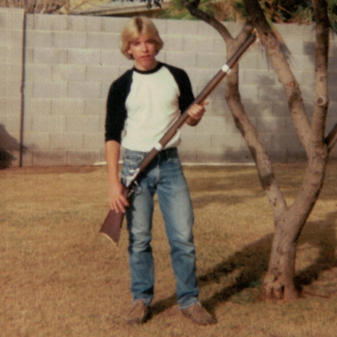 Robert holding a custom wood rifle he carved